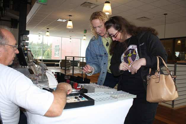 Barb Champ and Barbie Lumbert check out jewelry made by Ivan Gamradt during the Bonney Lake Senior Center's annual craft bazaar