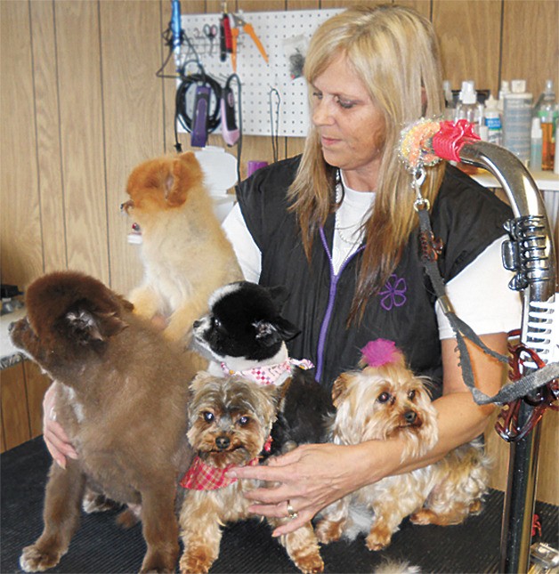Kim Beach with some of her four-legged clients. She plans to travel with her husband after she retires in June.