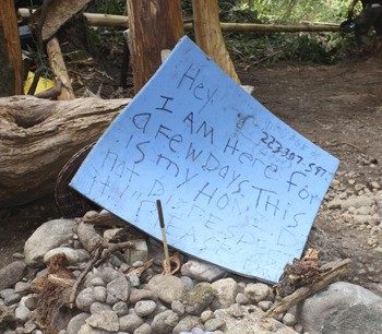 A sign found in the WSU Forest homeless camp.