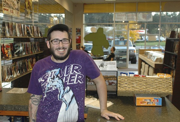 Austin Mansell mans the counter of his comic book shop