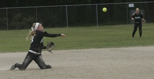 Kayla Wells races to send the ball to a baseman before a Yelm batter reaches safety.