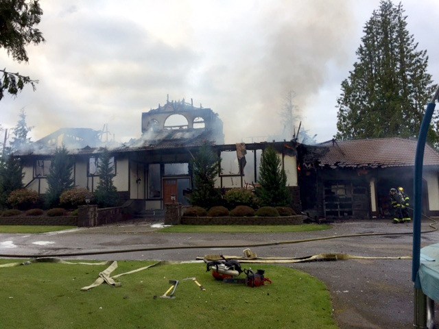 More than 20 firefighters worked Sunday to battle a house fire that left a Lake Tapps home destroyed.