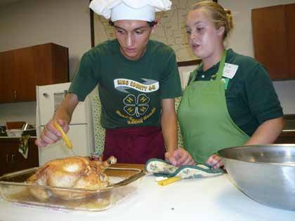 Chris Sechrist and teammate Christy Friend check on a roasted chick entree.