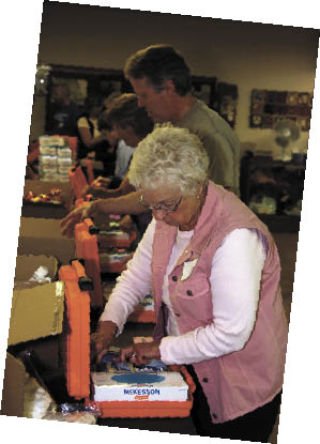 Enumclaw community volunteers packed up AIDS/HIV Caregiver Kits for a project sponsored by Enumclaw Rotary through World Vision. On June 6
