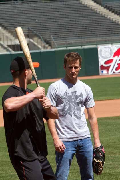 San Francisco Giants centerfielder Aaron Rowand shows Kasey Kahne how to swing a bat Tuesday.