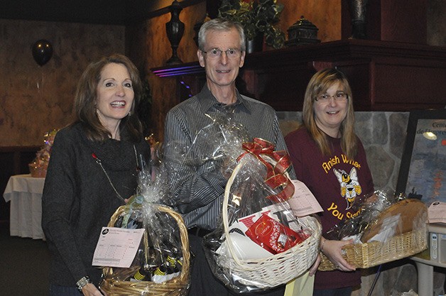 Oktoberfest auction bidders leave with their gift baskets.