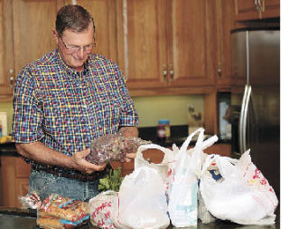 Tossing plastic grocery bags and replacing them with reusable cloth ones