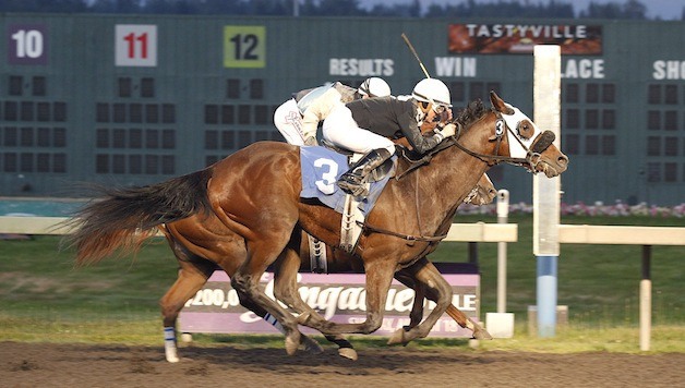 Risky Road (No. 3) and jockey Anne Sanguinetti edge Improviso by a head in the Friday feature race at Emerald Downs. June 21