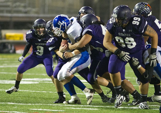 Sumner's defenders take down a North Mason player Friday night.