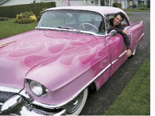 Elvis impersonator  Danny Vernon  sits in the driver’s seat of his pink-flamed 1956  Cadillac