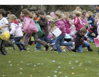 Several hundred children of all ages race through Allan Yorke Park Saturday morning to gather eggs during the annual Easter egg hunt hosted by the city of Bonney Lake. A couple of girls have their photograph taken with the Easter bunny at Bonney Lake. At Sunset Chev Stadium in Sumner
