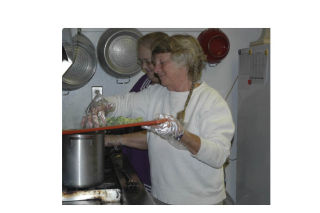 Linda Tallent and Fanzi Reichlin put together a meal during class at the senior center. Below