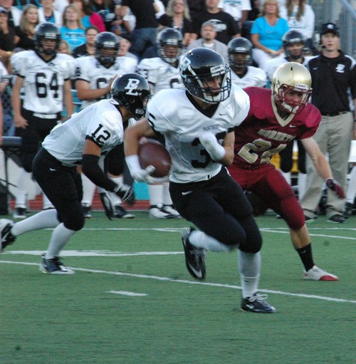 Panthers Quarterback Robert Combs evades pursuit while attempting to hotfoot the pigskin to the end zone Friday night. The Panthers took a 40-34 victory against White River