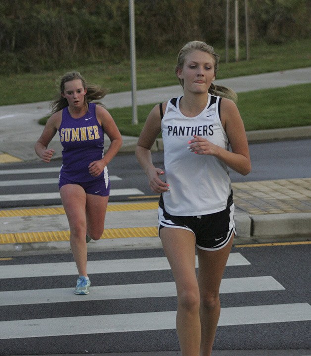 Sumner sophomore Hailey Holm and Bonney Lake freshman Kathleen Giosso run at Donald Eismann Elementary in Bonney Lake during the final cross country meet of the regular season.