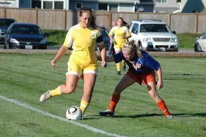 Enumclaw's Erin McCrillis holds off an Auburn Mountainview player during recent action.
