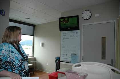 Cathi Dodson demonstrates how easy St. Elizabeth Hospital's video-on-demand patient information service is to use.