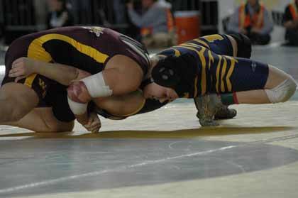 White River's Dylan Fagan goes for the pin during state girls wrestling at the Tacoma Dome Saturday.