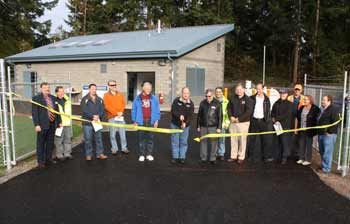 Mayor Neil Johnson cuts the ribbon at the new Prairie Ridge Booster Pump Station