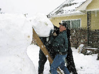 Yvette St. Luise said cars were driving by  with drivers chatting and saying Merry  Christmas throughout the afternoon as they continued to build their snowman.  She said folks continued to come by  well into the evening taking pictures.  She said one group noted