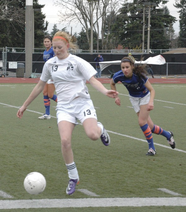 Bonney Lake Panther footballer Savannah Moorehouse runs with the ball while being pursued by Seattle Prep players. Seattle Prep went on to defeat the Panther girls 1-0.