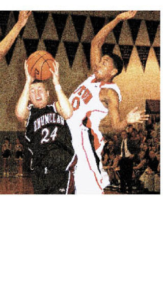Enumclaw’s Taylor Myers is fouled on his way to the hoop.