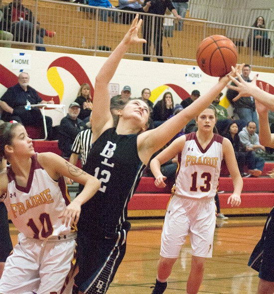 Forward Emily Stonerock  fights for a rebound Saturday against Prairie at Franklin Pierce High in the district playoffs.