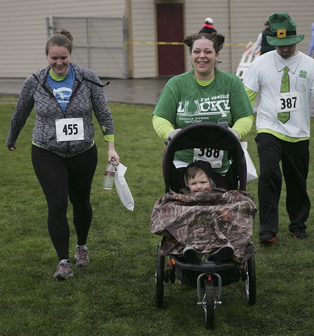 Katie and 2-year-old Luke Porubek with Amanda Wadleigh and Adam Porubek during the Enumclaw Chamber of Commerce St. Patrick's Day 5K run Saturday.