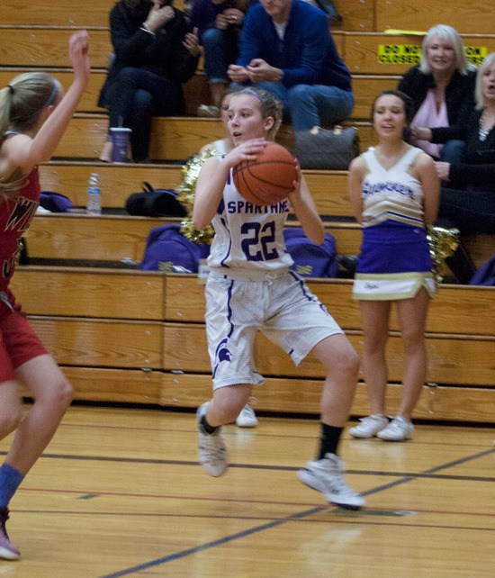 Freshman guard Kennedy Cutter looks for an open Spartan during Saturday’s district title game. Cutter finished the game with a team high 19 points. She was 5 for 8 from the three point line.