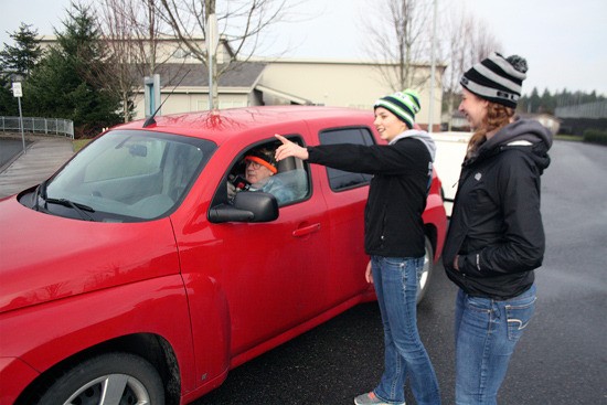 Bonney Lake seniors Kimmie and Chelsea help direct a resident to where he can recycle his batteries and freezer.