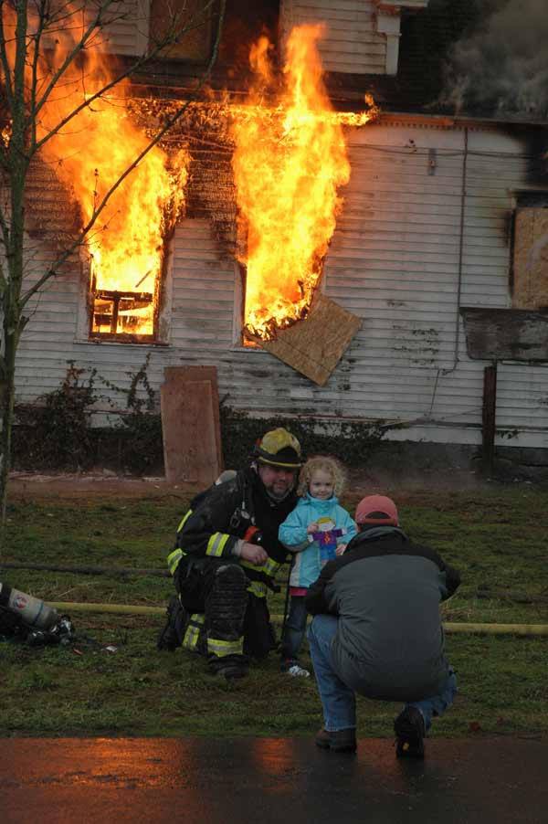 Firefighters and their families posed for pictures during a training burn Saturday at the Sumner Cemetery.