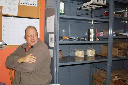 Bonney Lake Food Bank Executive Director Stew Bowen sits near an almost-empty shelf.