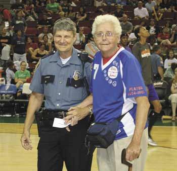 Bonney Lake's Joan Rupp stands with a Seattle Police woman during the halftime of the Aug. 16 Seattle Storm basketball game.