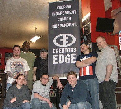 The members of Creator's Edge Press pose in front of their convention banner in the Comic Evolution shop. Back Row