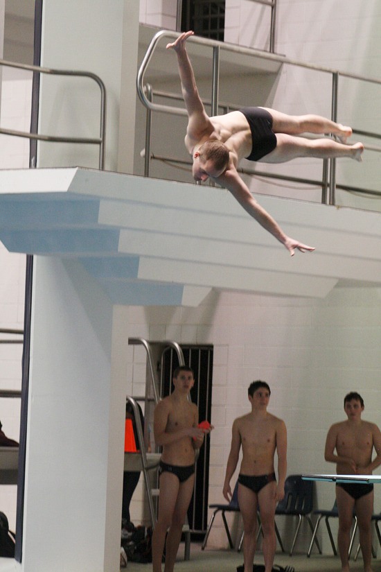 Reuben Madewell performs a 1/2 twist dive during the state swim championships. Madewell placed eighth overall in the diving competition.