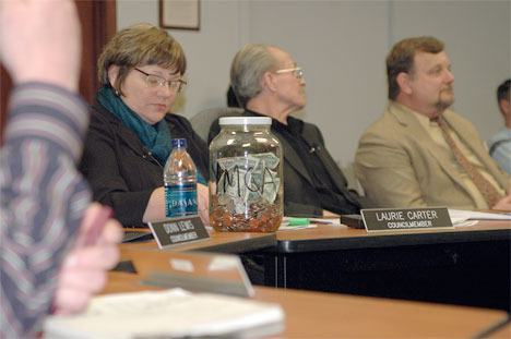 Bonney Lake Councilmember Laurie Carter takes notes during a discussion on the YMCA. Carter arrived at the meeting with the donation jar in front of her.
