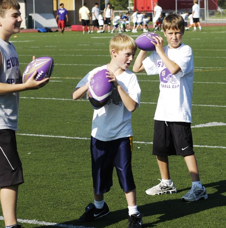 Boys at the Spartan Youth Football Camp prepare for passing drills.