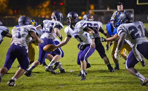 Sumner quarterback Chase Torgison hands the ball of to running back Brandon Tuilaepa during the game Friday