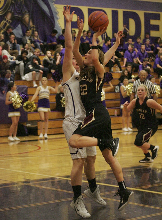 Kylie Rademacher drives to the hoop Friday at Sumner. The Hornets won 48-43.