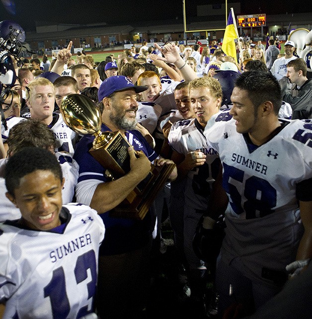 Sumner Spartans' coach Keith Ross celebrates with his team after winning the 2013 Sunset Bowl.