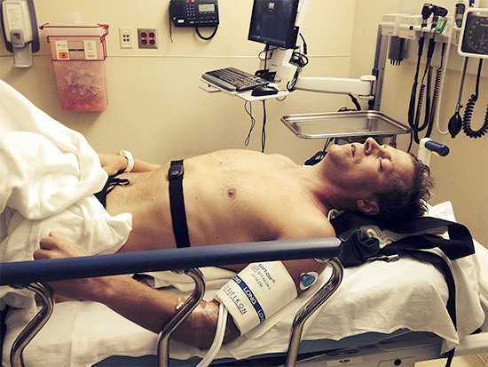 Dan Roach on a hospital bed after breaking his right collarbone and three ribs in a bike crash.