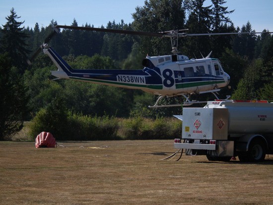 A Department of Natural Resources water chopper lands to refuel.