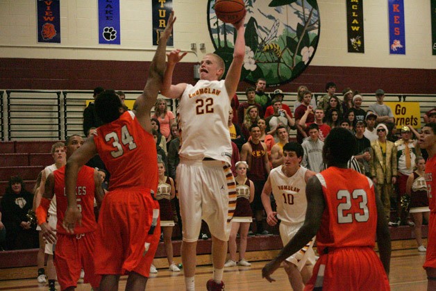 Enumclaw Hornet Drake Rademacher goes up for a sky hook over Jared Goldwire with Lakes in the Thursday game at home. The Hornets lost 52-49.