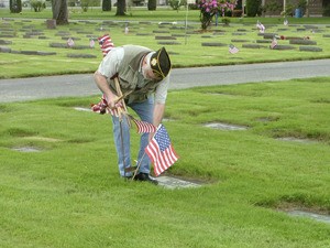 Vietnam veteran Tom Speckhardt places a flag at Sumner City Cemetery Thursday. Sumner VFW Post 3070 began placing flags at the cemetery in 1943. A Memorial Day service is held at the cemetery at 10 a.m. Monday.