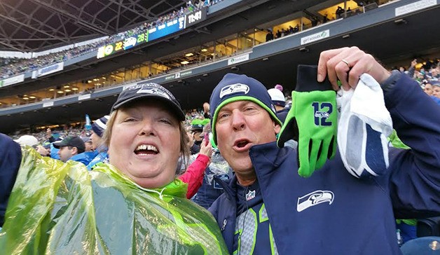 Laura and Brian Nelson from Lake Tapps celebrate the Seahawks 28-22 overtime win Sunday against the Green Bay Packers at CenturyLink Field.