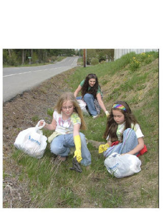 Janelle and Jolene Maloney celebrate Earth Day April 22 by picking up trash along 121st Street East in Bonney Lake with their mom