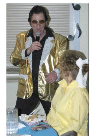 Elvis impersonator Dan Dornoff sings to a audience member during the annual Volunteer Recognition Dinners Saturday at the Bonney Lake Senior Center.