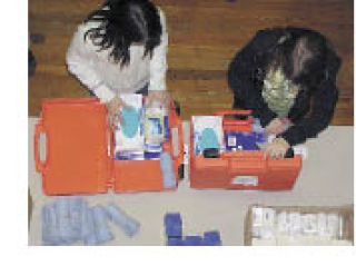 Local volunteers prepare the kits for use overseas.