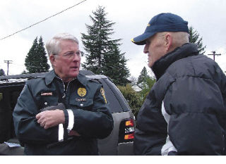 Art Sphar offers assistance to Curtis Lake on Jan. 8 after the Puyallup River flooded River Park Estates