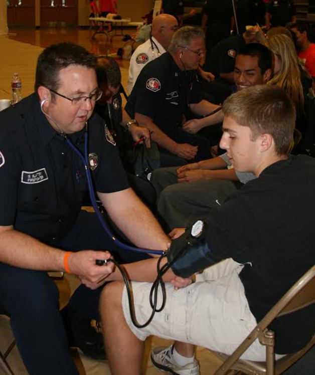 Bonney Lake’s Brian Grob gets his blood pressure checked by an East Pierce Fire volunteer on Friday.