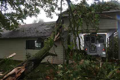 Curtis Stergion's home was damaged by a tree that was snapped off by Sunday's funnel cloud.